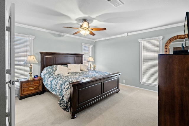 bedroom featuring baseboards, visible vents, light colored carpet, ceiling fan, and crown molding