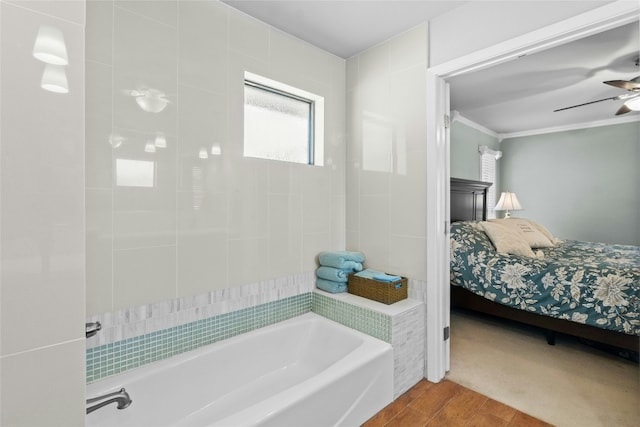 full bathroom featuring a bathing tub, ceiling fan, ornamental molding, wood finished floors, and ensuite bathroom