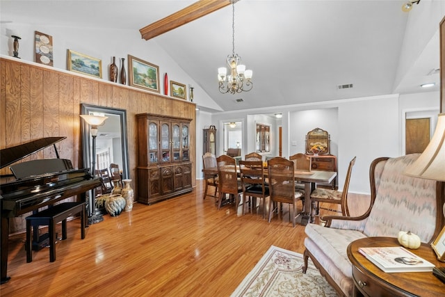 dining room featuring a chandelier, high vaulted ceiling, visible vents, light wood-type flooring, and beamed ceiling