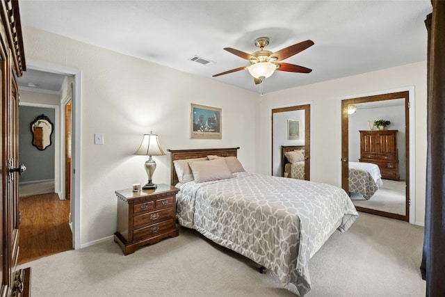 bedroom featuring carpet floors, visible vents, ceiling fan, and baseboards