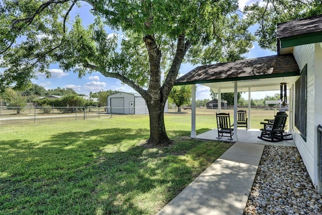 view of yard with an outbuilding and fence