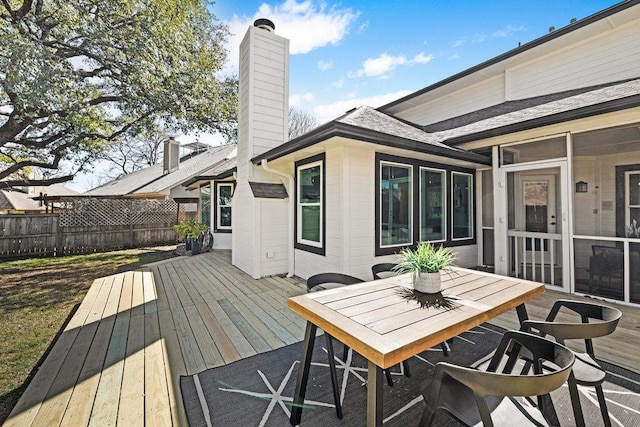 wooden deck with outdoor dining space and fence