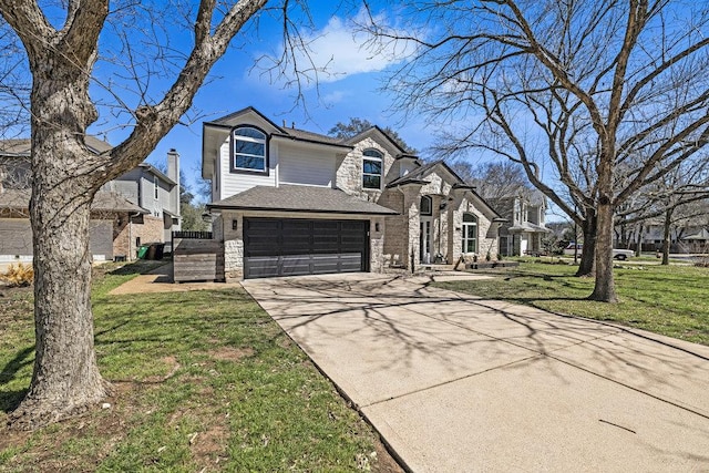 view of front of house featuring an attached garage, stone siding, concrete driveway, and a front yard