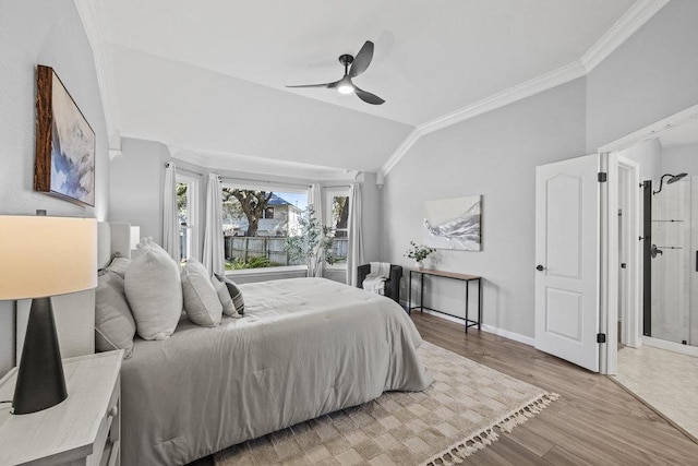 bedroom with light wood finished floors, baseboards, ornamental molding, and vaulted ceiling