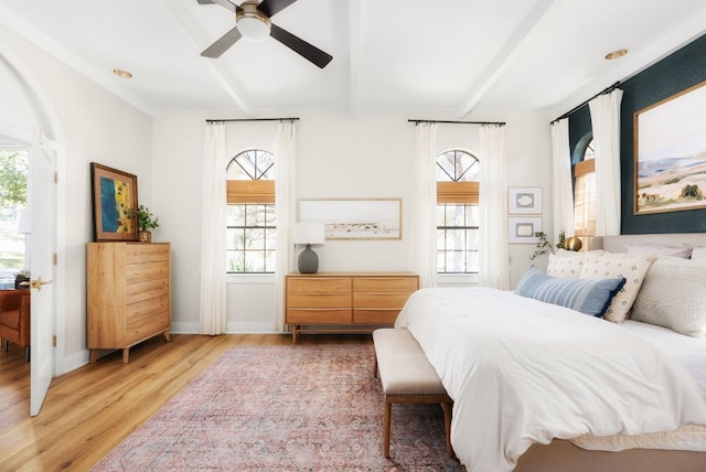 bedroom featuring multiple windows and beamed ceiling