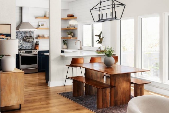 kitchen featuring open shelves, a wealth of natural light, a sink, and stainless steel range with electric stovetop