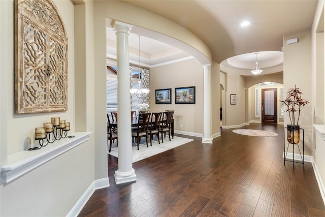 2717 Rain Song Dr, Leander, TX 78641 - entrance foyer featuring a raised ceiling, arched walkways, hardwood / wood-style floors, ornate columns, and recessed lighting