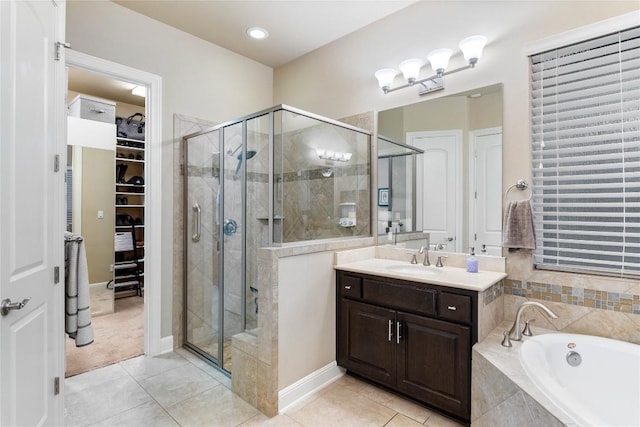 2717 Rain Song Dr, Leander, TX 78641 - full bath featuring tile patterned flooring, a shower stall, a bath, and a walk in closet