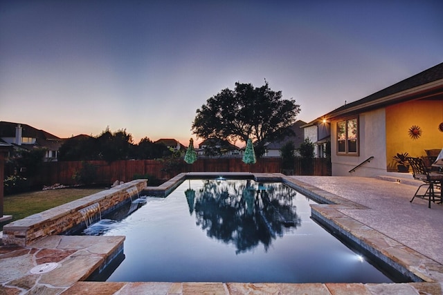 2717 Rain Song Dr, Leander, TX 78641 - pool at dusk featuring a fenced backyard and a patio area