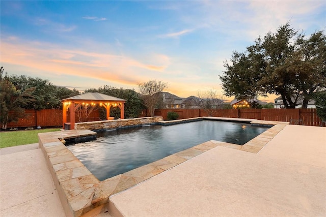 2717 Rain Song Dr, Leander, TX 78641 - pool at dusk with a gazebo, a patio, and a fenced backyard