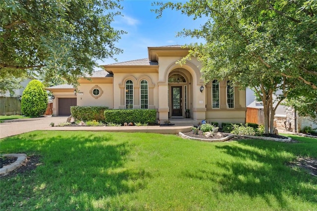 2717 Rain Song Dr, Leander, TX 78641 - mediterranean / spanish house with a front yard, a garage, driveway, and stucco siding