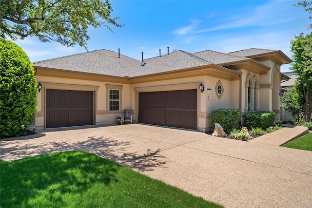 2717 Rain Song Dr, Leander, TX 78641 - ranch-style home with concrete driveway, an attached garage, stucco siding, and a shingled roof