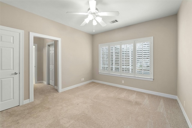 unfurnished room featuring light carpet, visible vents, and baseboards