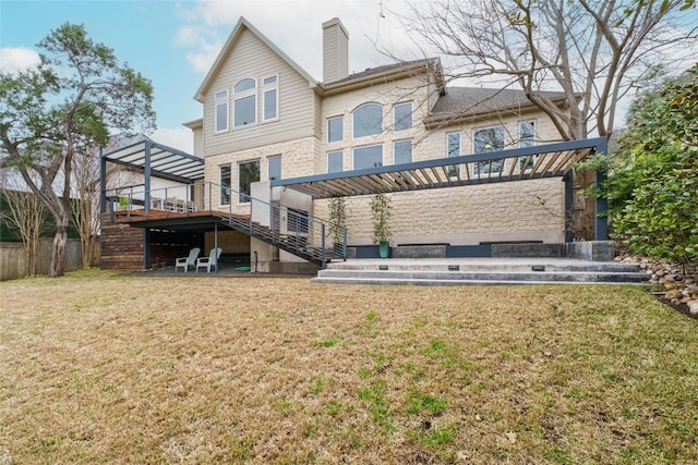 rear view of property with a chimney, stairway, a deck, and a lawn