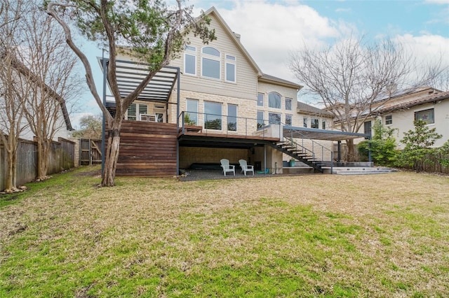 back of house with a deck, a fenced backyard, a yard, and stairway