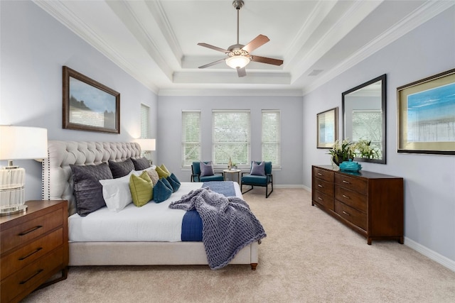 bedroom with light carpet, baseboards, a raised ceiling, and crown molding