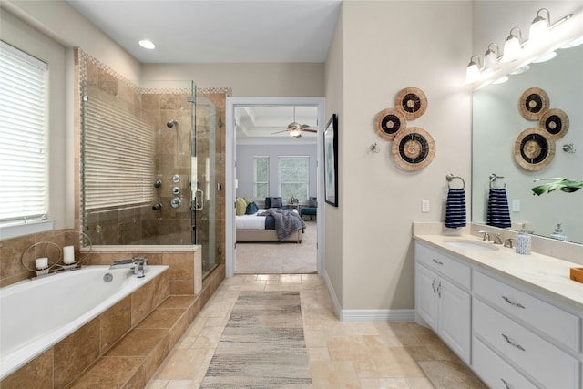 ensuite bathroom featuring baseboards, ensuite bathroom, a garden tub, vanity, and a shower stall