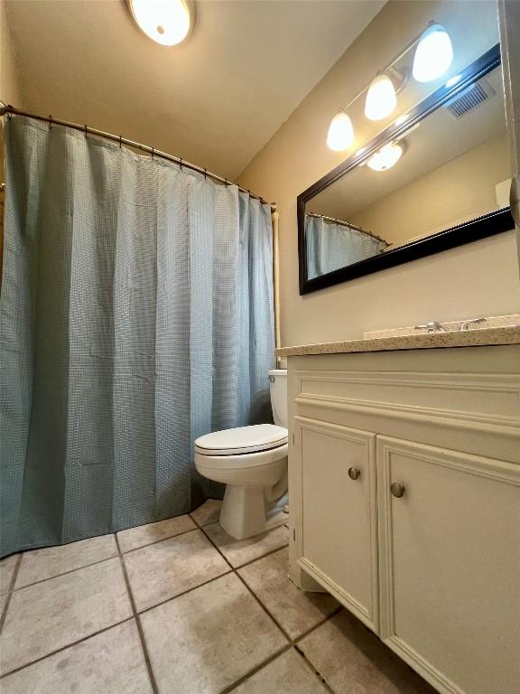 full bath with tile patterned flooring, visible vents, vanity, and toilet