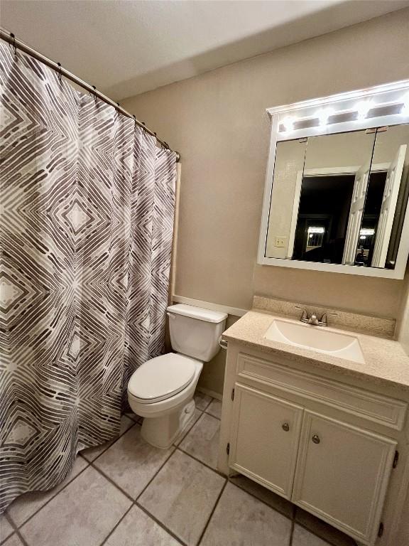 full bathroom featuring tile patterned flooring, vanity, and toilet