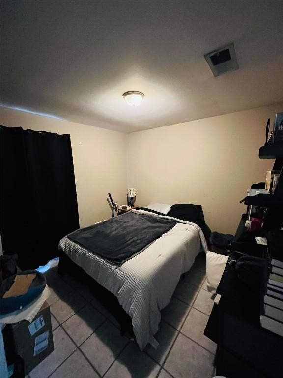 bedroom featuring visible vents and light tile patterned floors