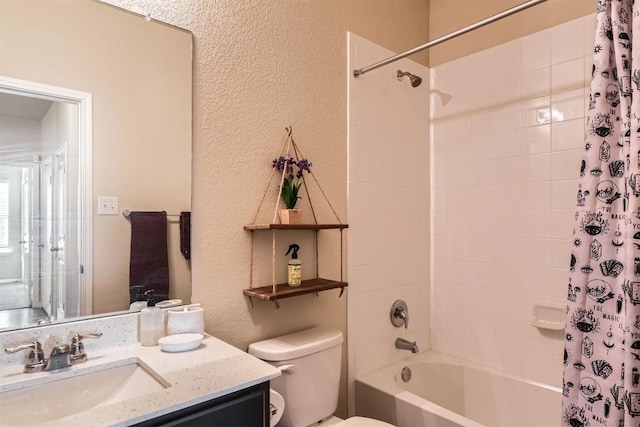 full bath with shower / bath combination with curtain, a textured wall, vanity, and toilet