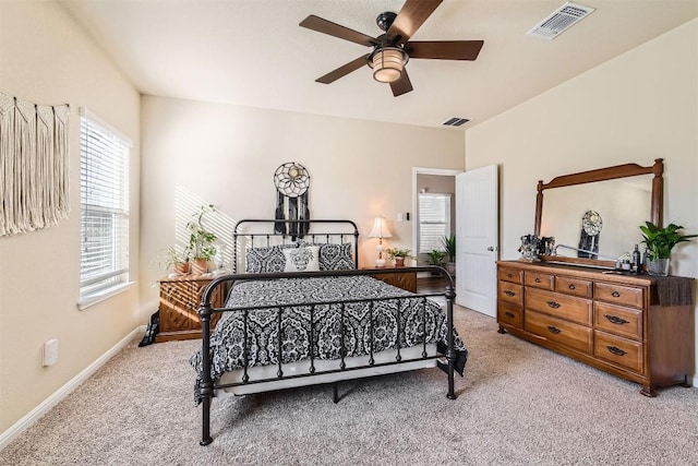 bedroom featuring light carpet, baseboards, visible vents, and a ceiling fan