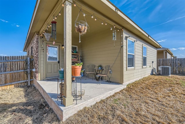 back of property with a patio area, fence, and central AC unit