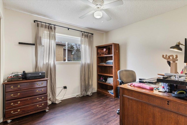 office space featuring a textured ceiling, dark wood-type flooring, a ceiling fan, and baseboards