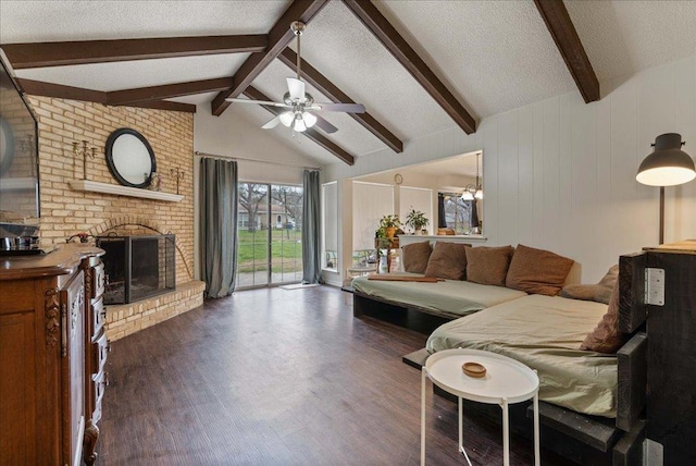 living room featuring a textured ceiling, a brick fireplace, dark wood finished floors, and vaulted ceiling with beams