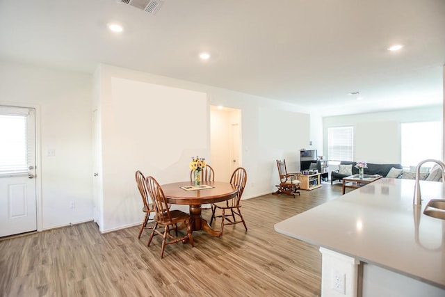 dining space featuring light wood-type flooring, visible vents, and recessed lighting