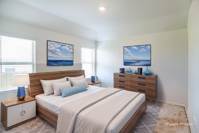 bedroom featuring light carpet