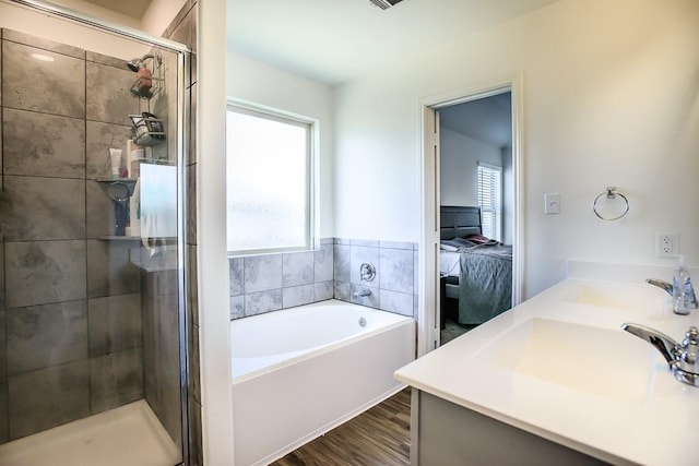 full bathroom featuring a stall shower, wood finished floors, ensuite bathroom, vanity, and a bath