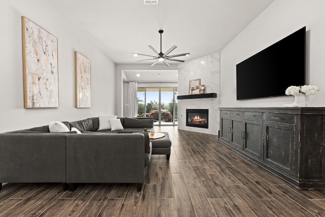 living room featuring a fireplace, visible vents, and wood tiled floor