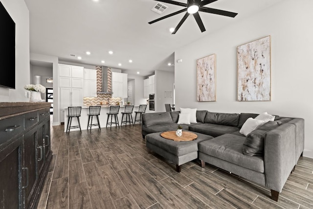 living area with dark wood-type flooring, recessed lighting, visible vents, and ceiling fan