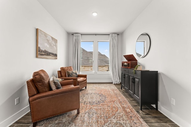 living area featuring dark wood-type flooring and baseboards