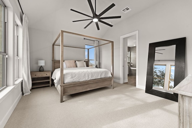 carpeted bedroom featuring visible vents, baseboards, vaulted ceiling, and a ceiling fan