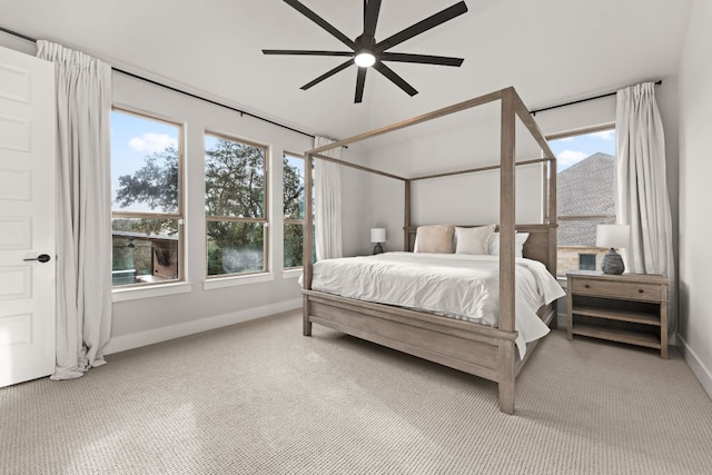 carpeted bedroom with a ceiling fan and baseboards