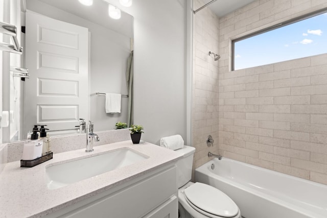 bathroom featuring toilet, vanity, and shower / bathtub combination