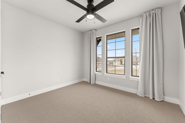 unfurnished room with ceiling fan, baseboards, and light colored carpet