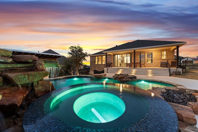 view of swimming pool featuring a pool with connected hot tub