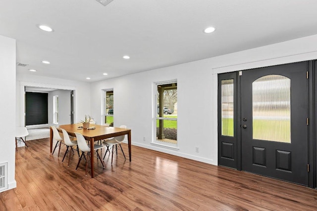 dining space with recessed lighting, visible vents, baseboards, and wood finished floors