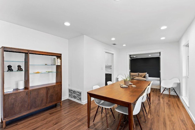 dining space featuring baseboards, wood finished floors, visible vents, and recessed lighting