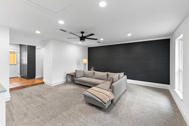 living room featuring recessed lighting, carpet flooring, visible vents, and baseboards