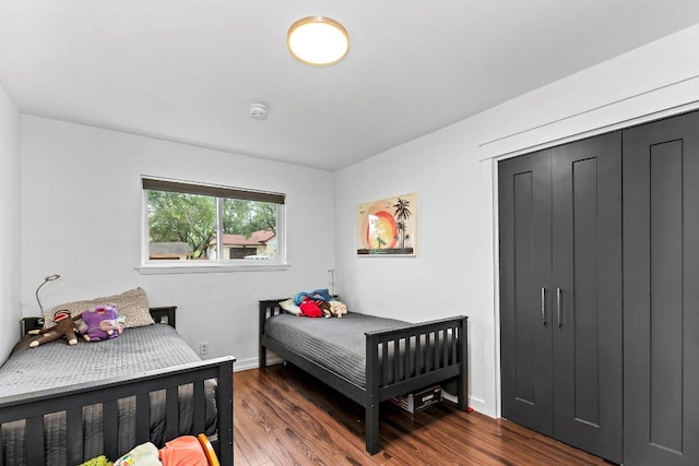 bedroom with baseboards and wood finished floors