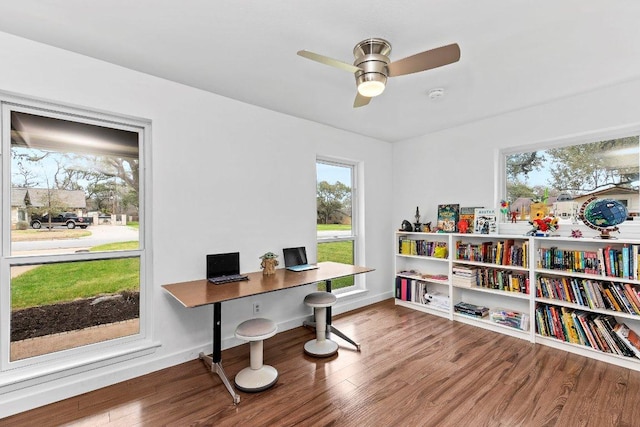 office area featuring a ceiling fan, baseboards, and wood finished floors