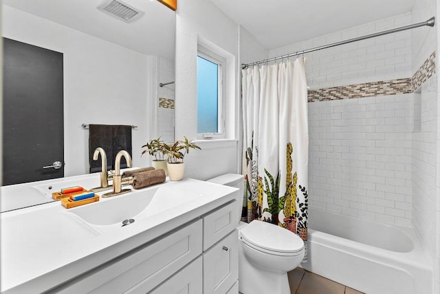 full bath featuring tile patterned flooring, toilet, shower / tub combo, vanity, and visible vents