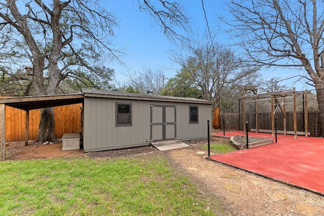 view of outbuilding with an outbuilding and fence