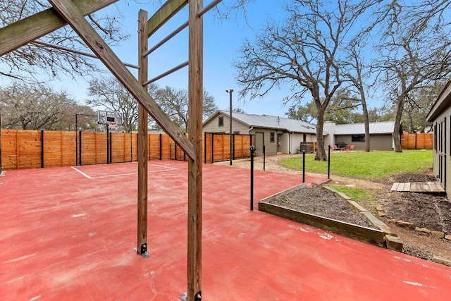 view of patio with basketball hoop and fence