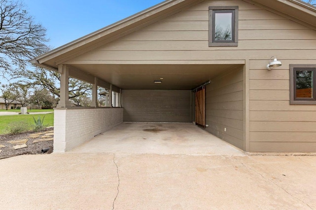 view of vehicle parking with a carport and concrete driveway