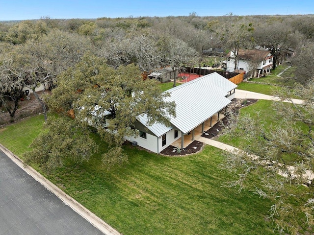 birds eye view of property featuring a view of trees